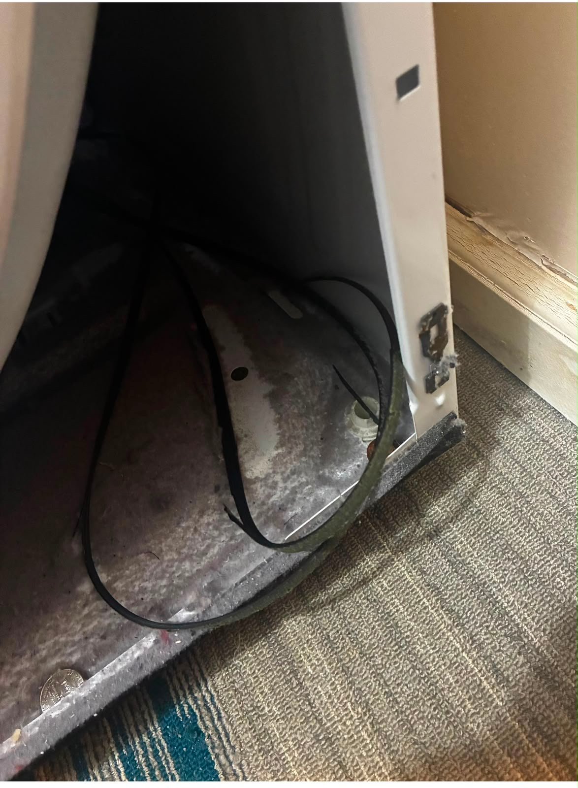 The bottom corner of a dryer with the drive belt off
