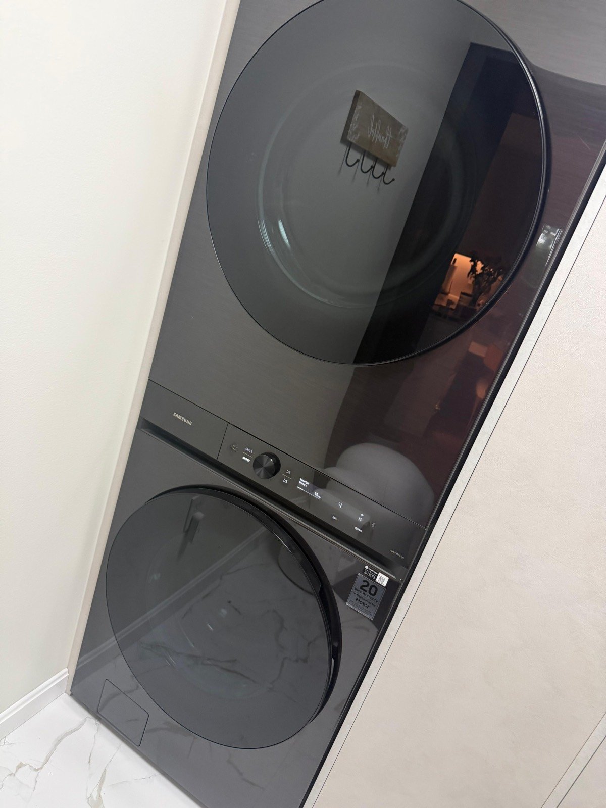 Stacked Samsung washer and dryer in a laundry nook