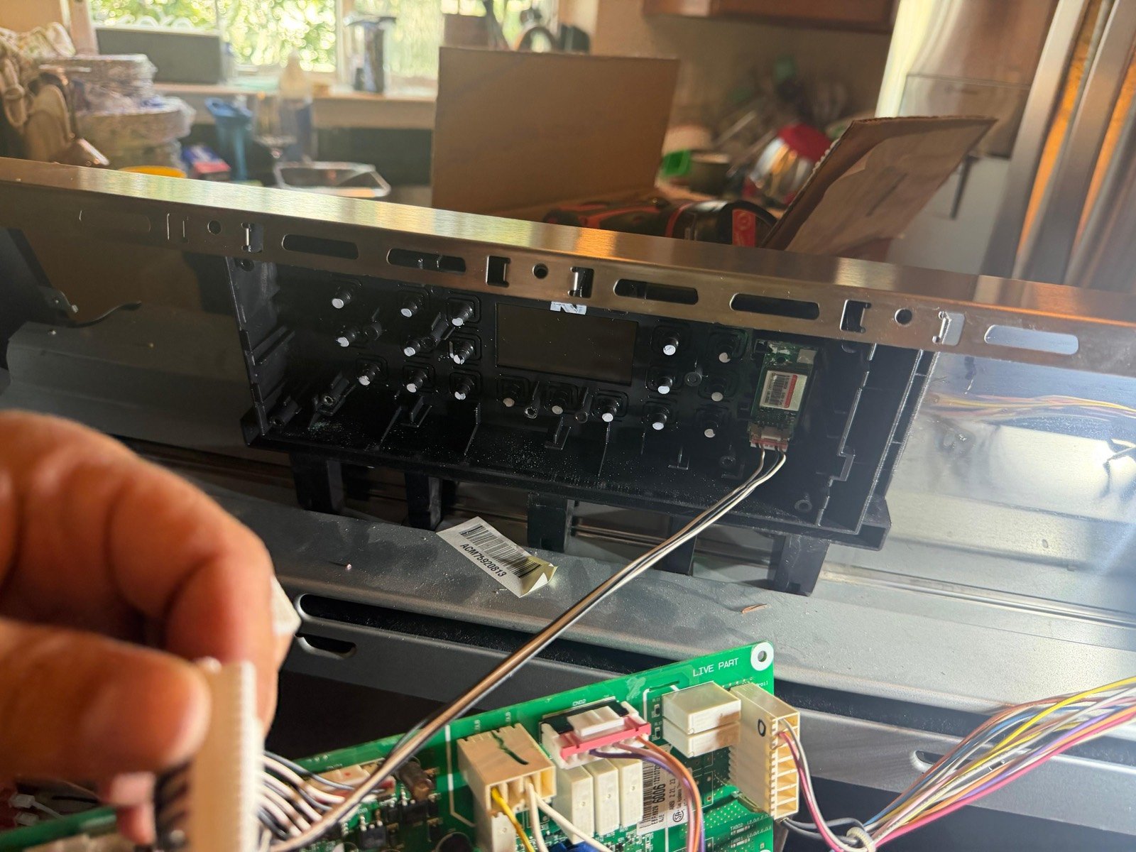 Range control panel disassembled for board-level diagnosis