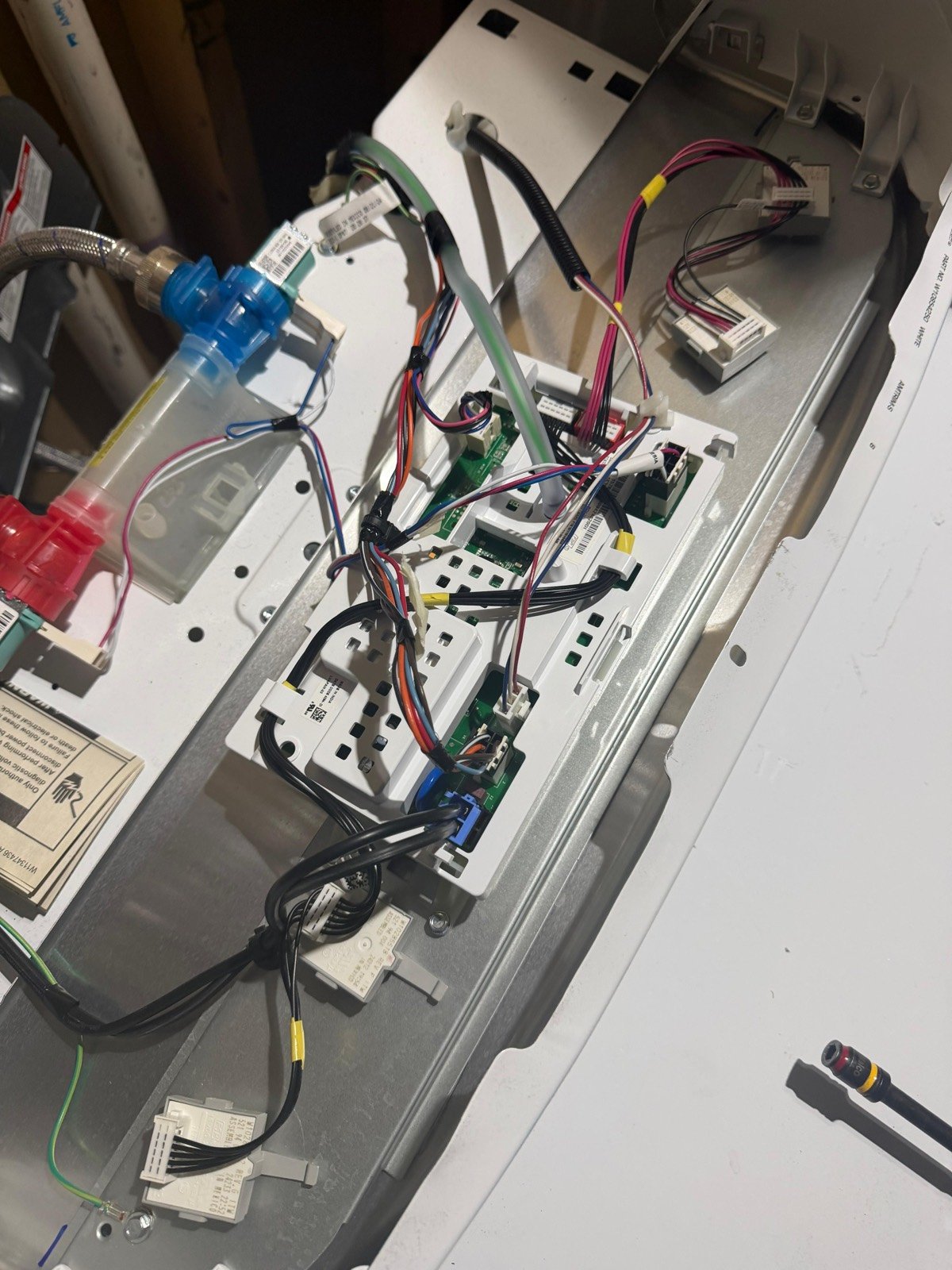 Top-load washer control boards and water valves exposed