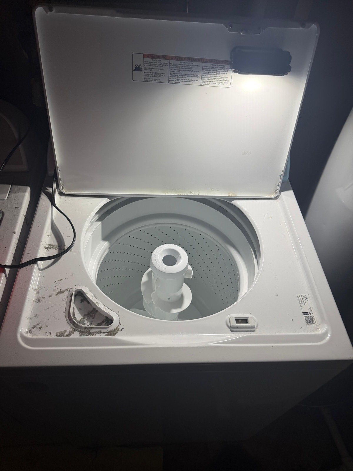 Top-load washer with the lid open during service