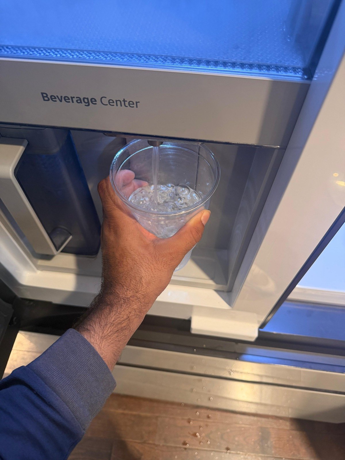 Water dispenser tested with a clear cup after repair